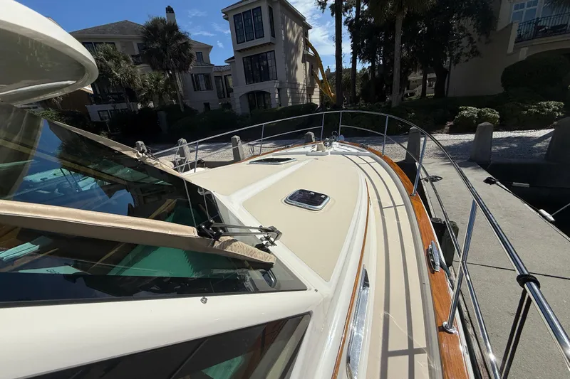 Strange Magic Yacht Photos Pics 2023 Sabre 43 Salon Express yacht docked near luxury waterfront homes.