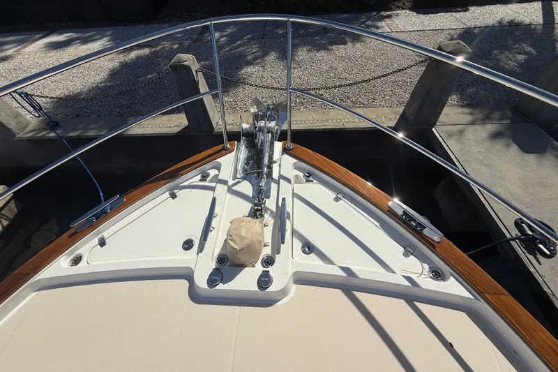 Strange Magic Yacht Photos Pics Bow of 2023 Sabre 43 Salon Express yacht with anchor and railings.