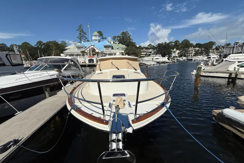Strange Magic Yacht Photos Pics 2023 Sabre 43 Salon Express yacht docked at a marina under a clear blue sky.