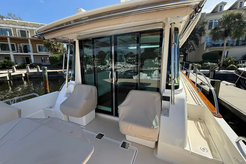 Strange Magic Yacht Photos Pics 2023 Sabre 43 Salon Express yacht docked, featuring covered seating and glass doors.