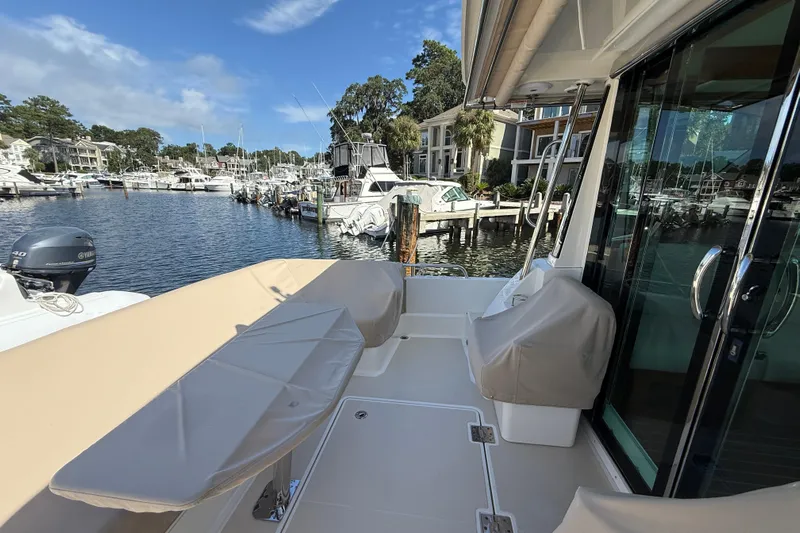 Strange Magic Yacht Photos Pics 2023 Sabre 43 Salon Express yacht docked at a marina, showcasing its spacious deck.