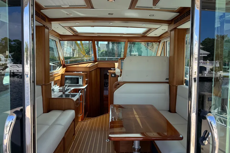 Strange Magic Yacht Photos Pics Interior of 2023 Sabre 43 Salon Express yacht with elegant wood finish.