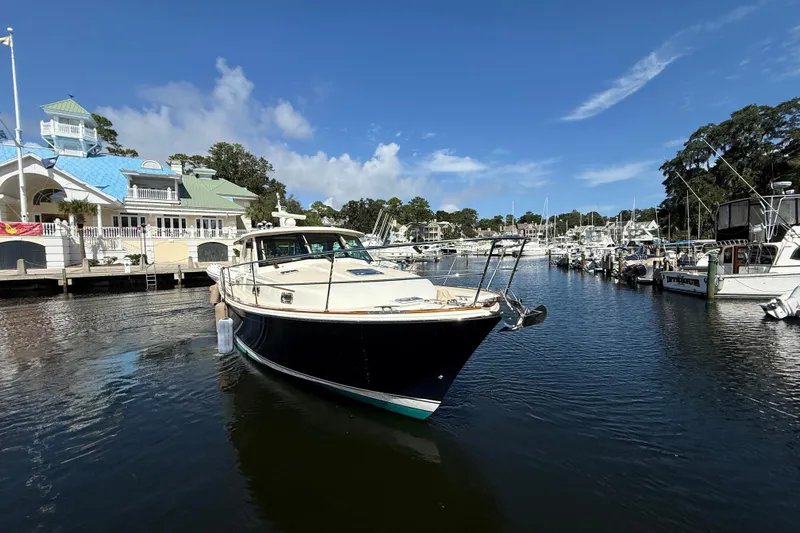 Strange Magic Yacht Photos Pics 2023 Sabre 43 Salon Express yacht docked at a marina under a clear blue sky.