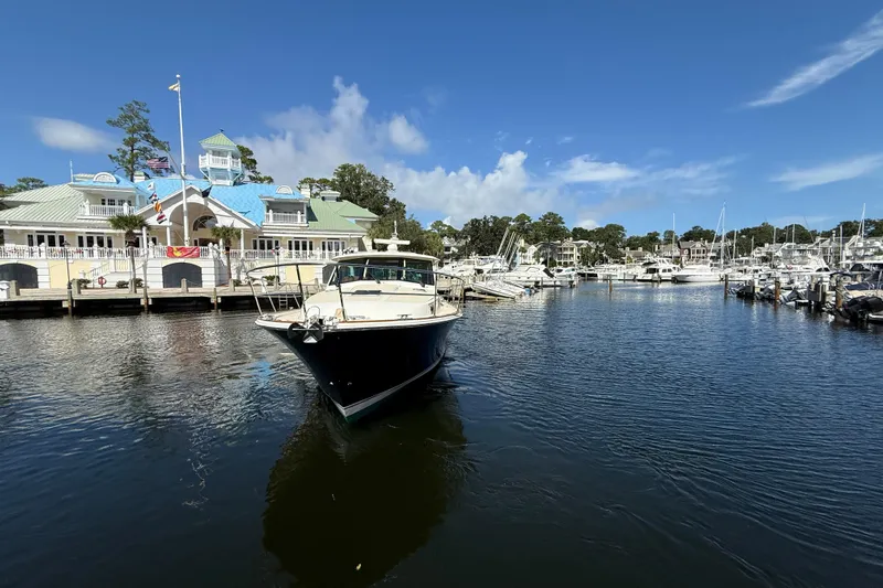 Strange Magic Yacht Photos Pics 2023 Sabre 43 Salon Express yacht docked at a marina under a clear blue sky.