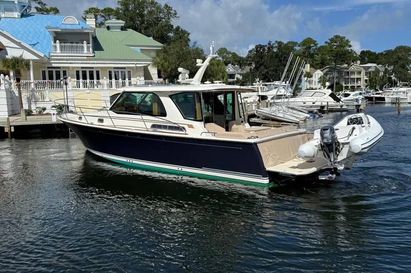 Strange Magic Yacht Photos Pics 2023 Sabre 43 Salon Express yacht docked in a marina, surrounded by other boats.