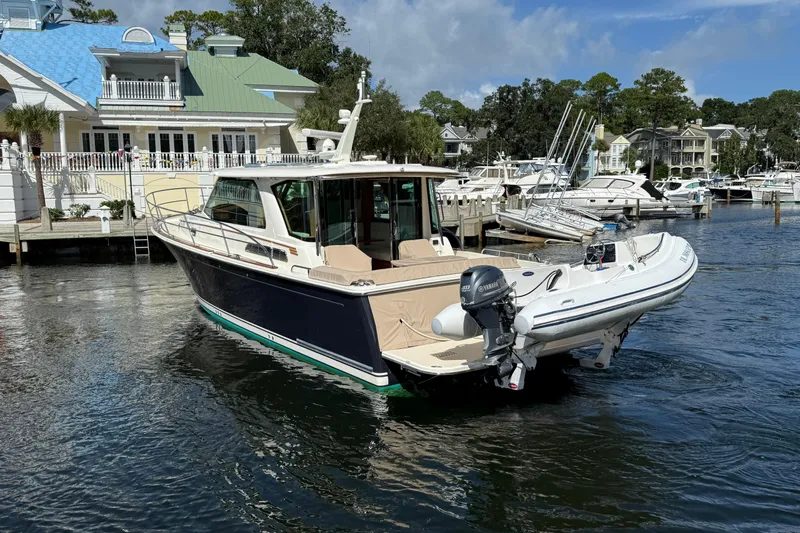 Strange Magic Yacht Photos Pics 2023 Sabre 43 Salon Express yacht docked at a marina with a tender boat.