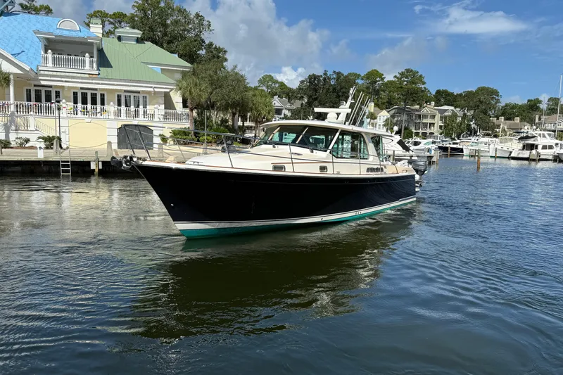 Strange Magic Yacht Photos Pics 2023 Sabre 43 Salon Express yacht docked in a scenic marina setting.