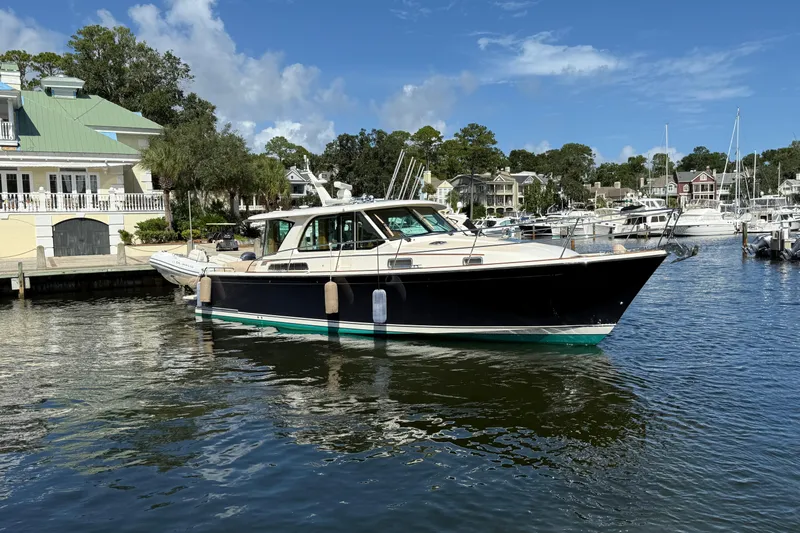 Strange Magic Yacht Photos Pics 2023 Sabre 43 Salon Express yacht docked in a scenic marina setting.