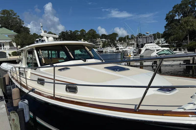 Strange Magic Yacht Photos Pics 2023 Sabre 43 Salon Express yacht docked at a marina under a clear blue sky.