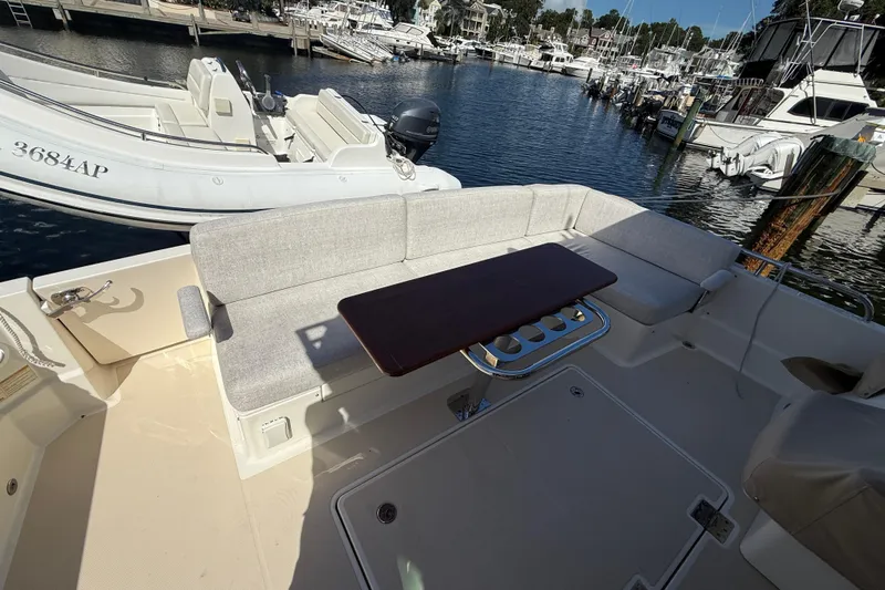 Strange Magic Yacht Photos Pics 2023 Sabre 43 Salon Express yacht with outdoor seating and table at marina.