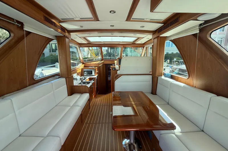 Strange Magic Yacht Photos Pics Luxurious interior of 2023 Sabre 43 Salon Express yacht with elegant wood and white seating.