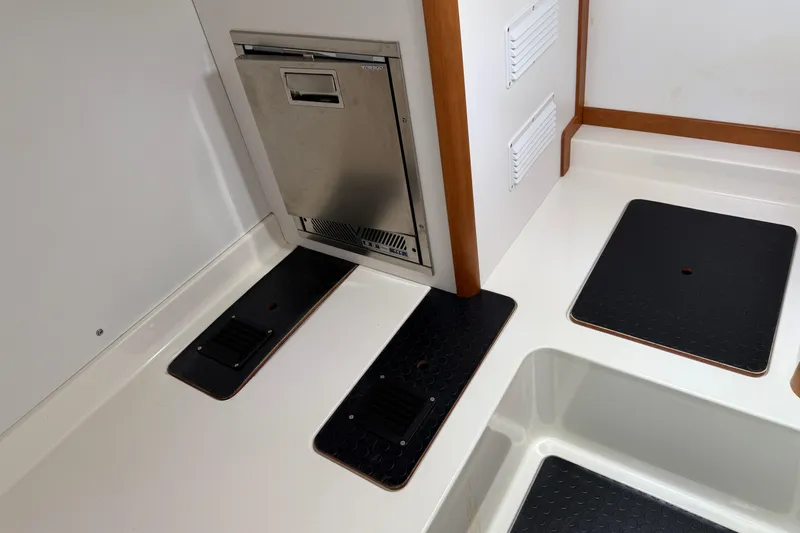 Strange Magic Yacht Photos Pics 2023 Sabre 43 Salon Express interior with stainless steel appliance and black floor panels.