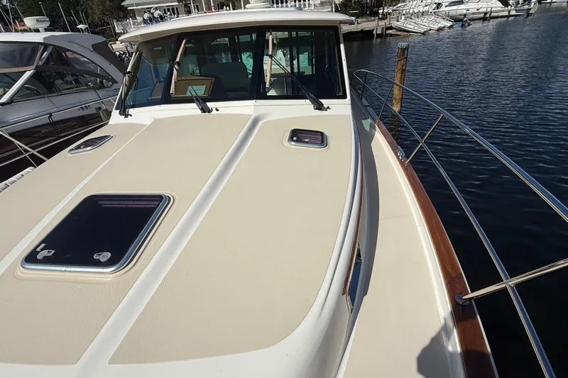 Strange Magic Yacht Photos Pics 2023 Sabre 43 Salon Express yacht docked at marina, showcasing sleek deck design.