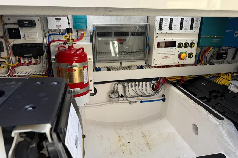 Strange Magic Yacht Photos Pics Engine room of 2023 Sabre 43 Salon Express with electrical panels and fire extinguisher.