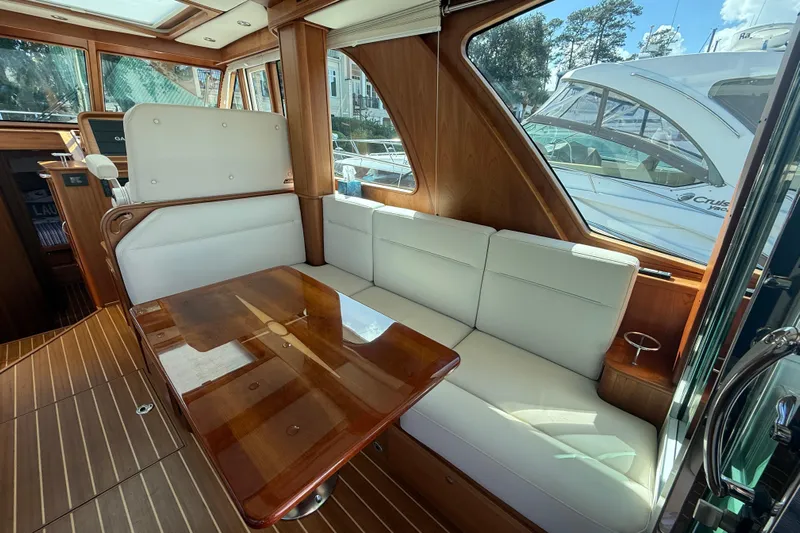 Strange Magic Yacht Photos Pics Interior of 2023 Sabre 43 Salon Express yacht with elegant seating and wooden table.