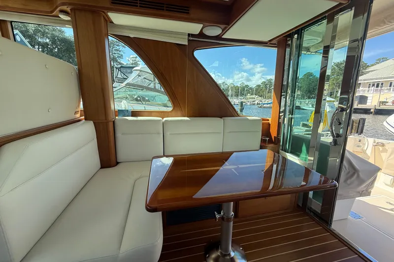 Strange Magic Yacht Photos Pics Interior of 2023 Sabre 43 Salon Express yacht with elegant seating and wooden table.