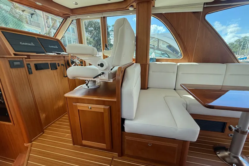 Strange Magic Yacht Photos Pics 2023 Sabre 43 Salon Express interior with white seating and wooden accents.