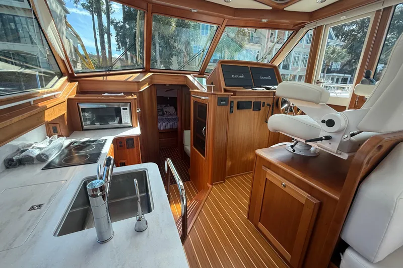 Strange Magic Yacht Photos Pics Interior of 2023 Sabre 43 Salon Express yacht with modern kitchen and helm.