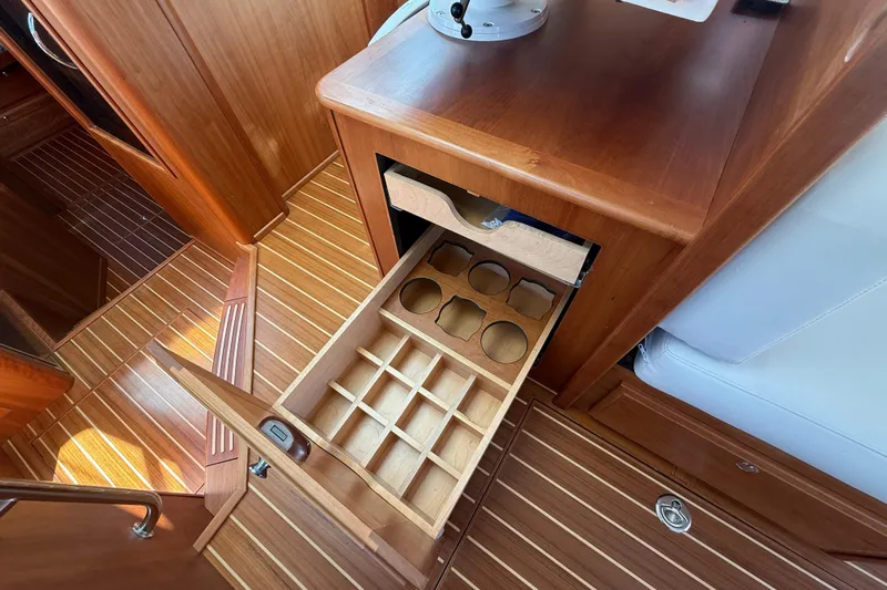 Strange Magic Yacht Photos Pics 2023 Sabre 43 Salon Express interior with open wooden storage drawers.