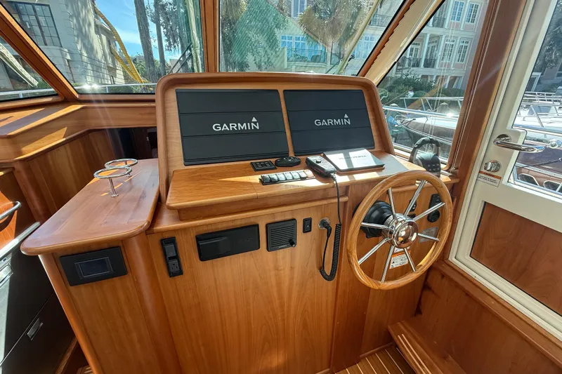 Strange Magic Yacht Photos Pics 2023 Sabre 43 Salon Express helm with Garmin displays and wooden steering wheel.