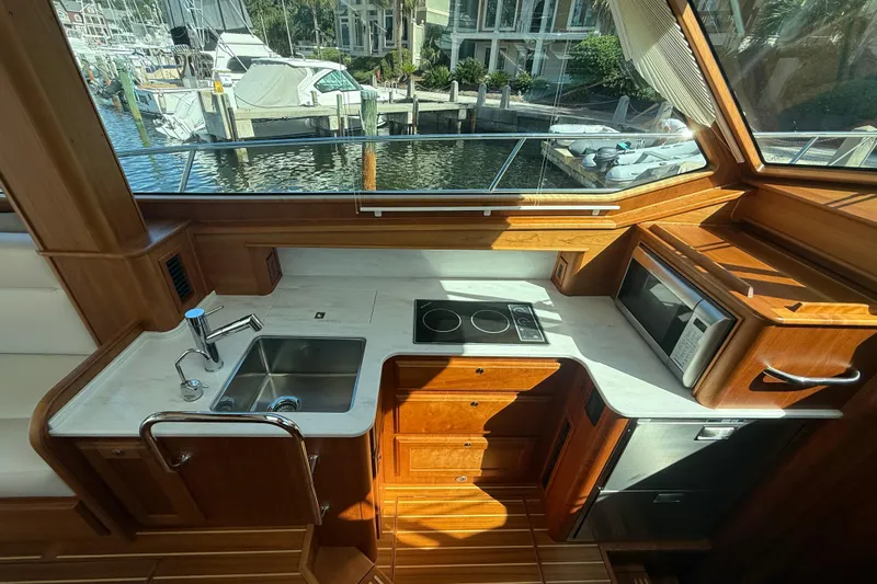 Strange Magic Yacht Photos Pics Luxurious 2023 Sabre 43 Salon Express yacht kitchen with modern appliances and waterfront view.