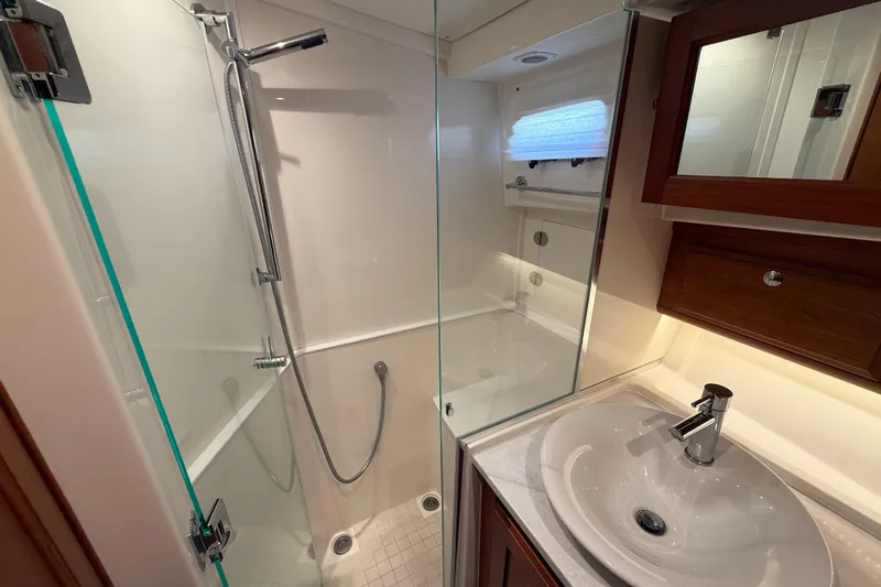 Strange Magic Yacht Photos Pics Luxurious bathroom in 2023 Sabre 43 Salon Express yacht with modern shower and sink.