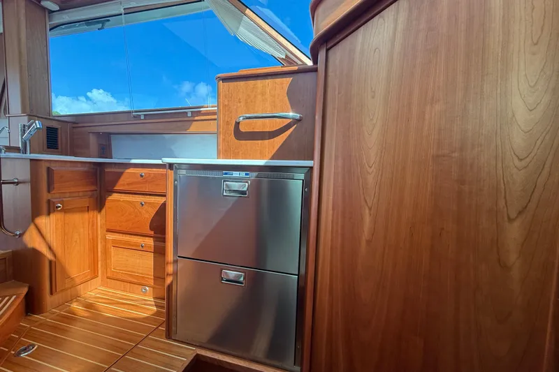 Strange Magic Yacht Photos Pics Interior of 2023 Sabre 43 Salon Express yacht with wooden cabinetry and stainless steel appliances.