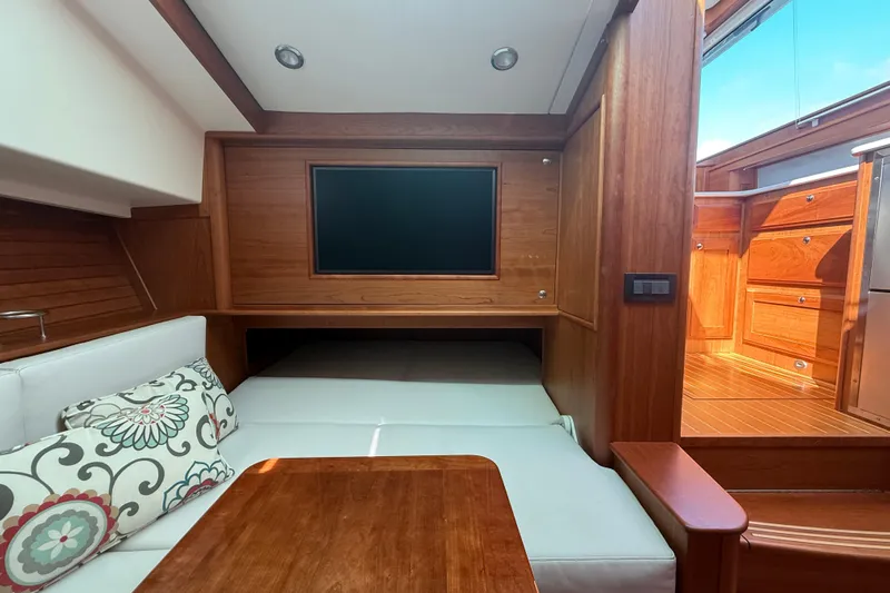 Strange Magic Yacht Photos Pics Interior of 2023 Sabre 43 Salon Express yacht with wood finish and cozy seating area.