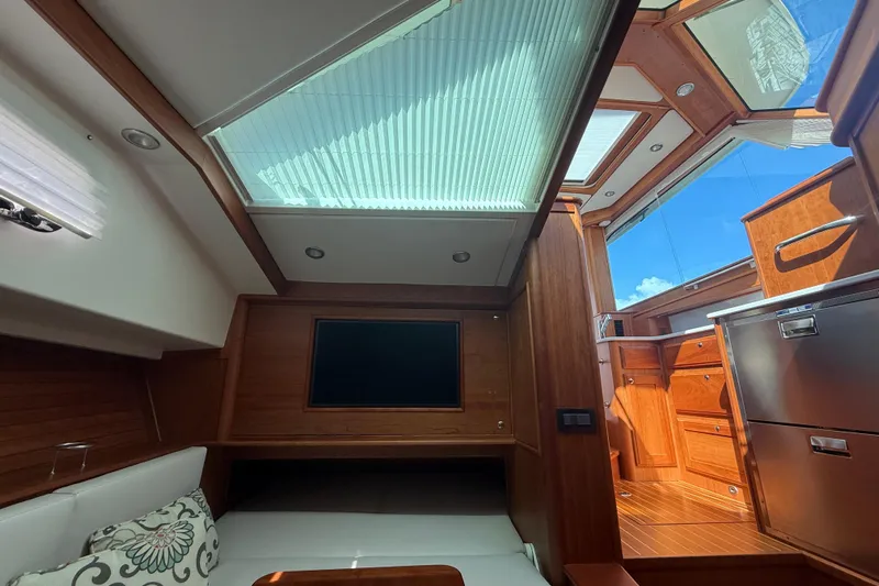 Strange Magic Yacht Photos Pics Interior of 2023 Sabre 43 Salon Express yacht with skylight and wooden finishes.
