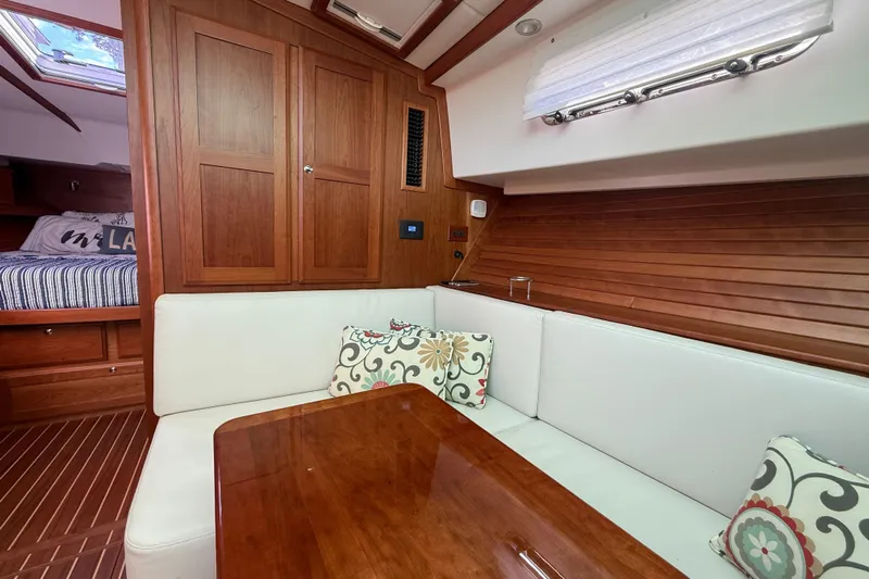Strange Magic Yacht Photos Pics Luxurious interior of 2023 Sabre 43 Salon Express yacht with wood paneling and cozy seating.