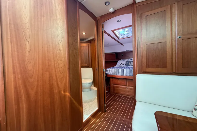 Strange Magic Yacht Photos Pics 2023 Sabre 43 Salon Express interior with wood finish, bedroom, and bathroom.