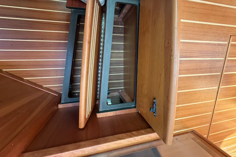 Strange Magic Yacht Photos Pics Open wooden cabinet on 2023 Sabre 43 Salon Express yacht interior.