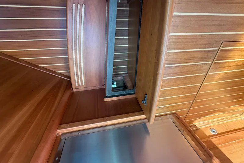 Strange Magic Yacht Photos Pics 2023 Sabre 43 Salon Express interior with open wooden cabinet and sleek design.