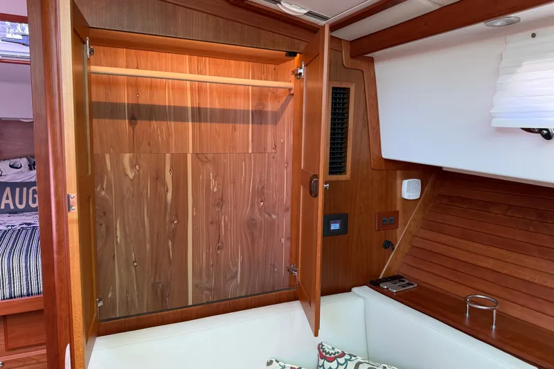 Strange Magic Yacht Photos Pics 2023 Sabre 43 Salon Express interior with open wooden cabinet and cozy seating area.