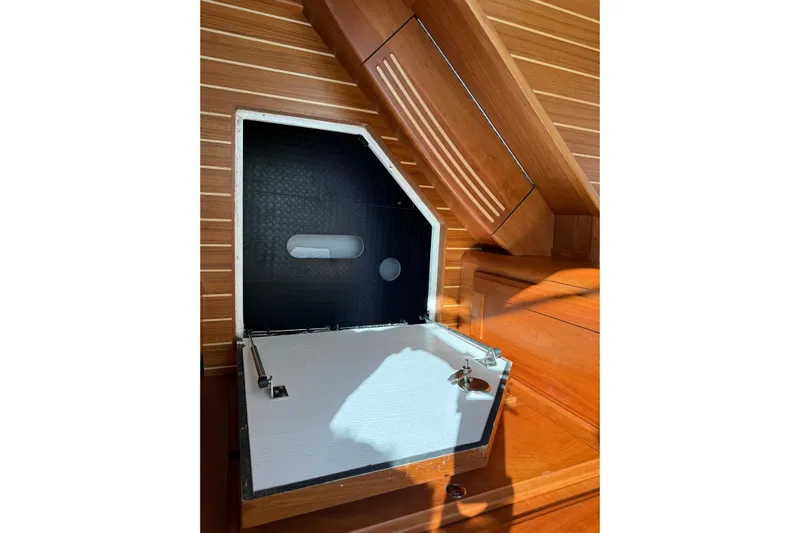 Strange Magic Yacht Photos Pics 2023 Sabre 43 Salon Express interior storage compartment with wooden finish.