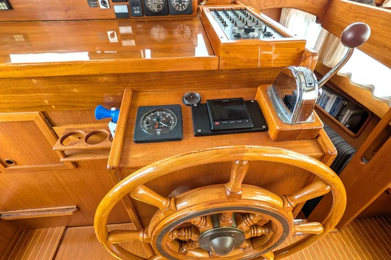 Firefly Yacht Photos Pics Wooden helm station of 1985 Siltala Nauticat 44 with compass and throttle controls.
