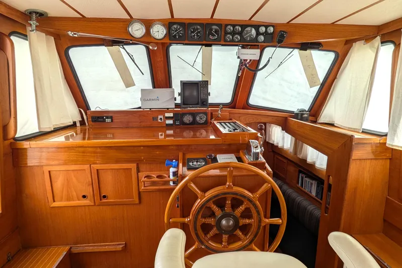 Firefly Yacht Photos Pics Interior of 1985 Siltala Nauticat 44 yacht with wooden helm and navigation instruments.