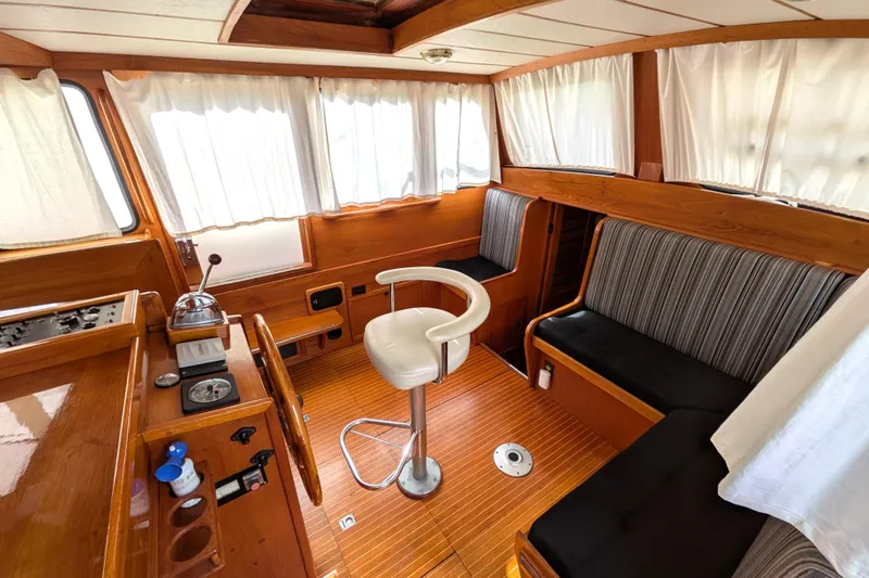 Firefly Yacht Photos Pics Interior of 1985 Siltala Nauticat 44 yacht with wooden finish and seating area.