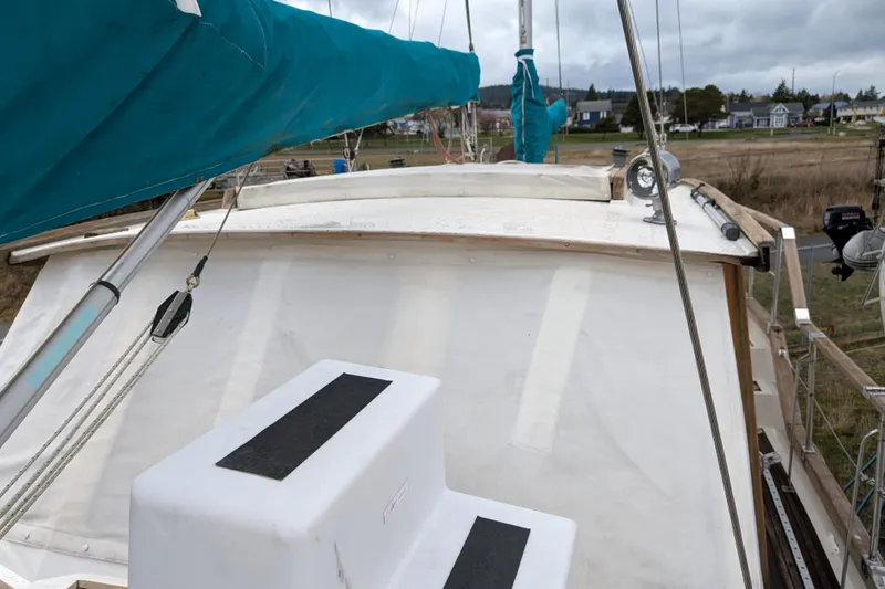 Firefly Yacht Photos Pics 1985 Siltala Nauticat 44 sailboat deck with blue sail cover, docked in a marina.