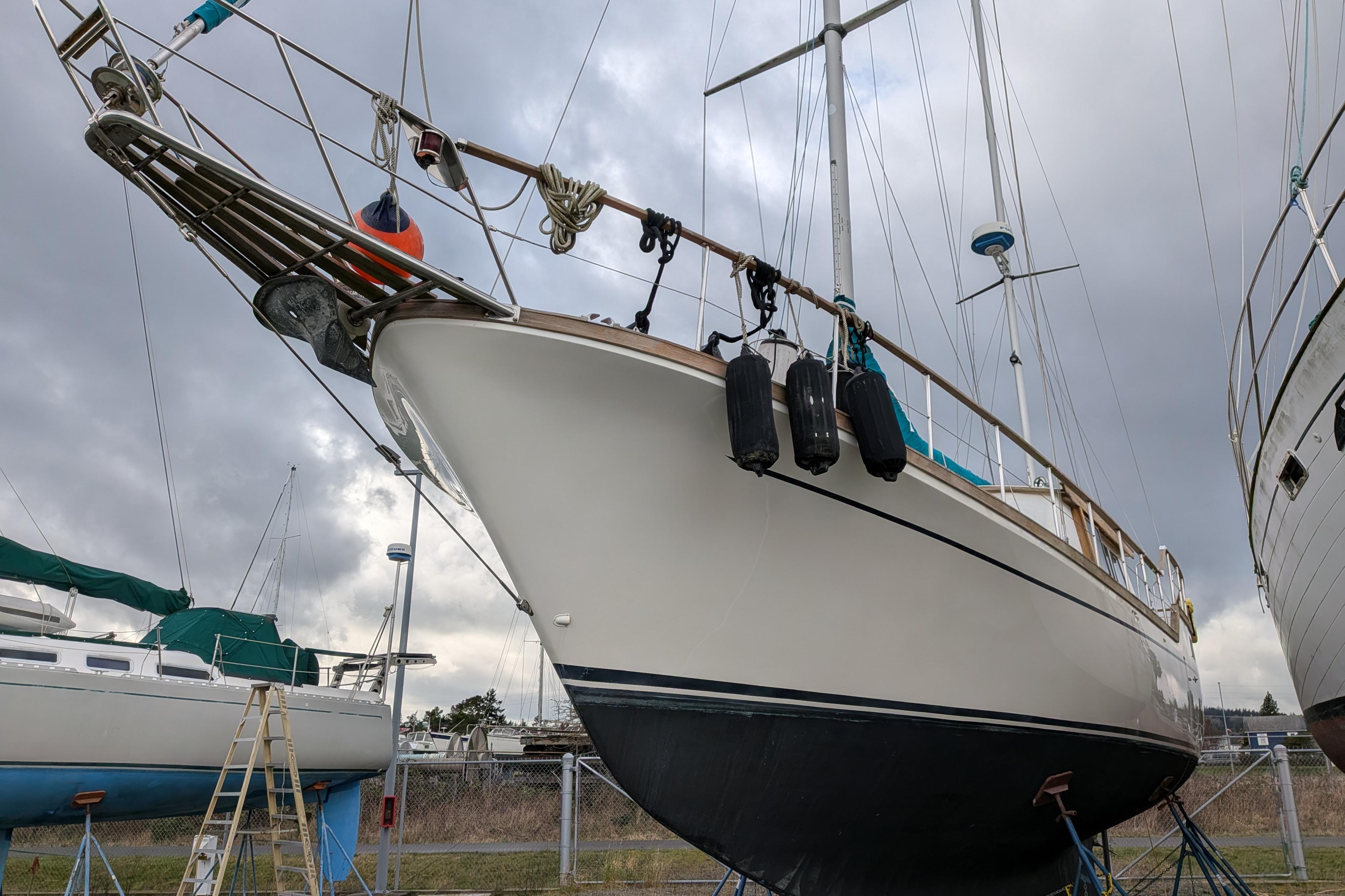 1985 Siltala Nauticat 44 sailboat on dry dock, cloudy sky background.