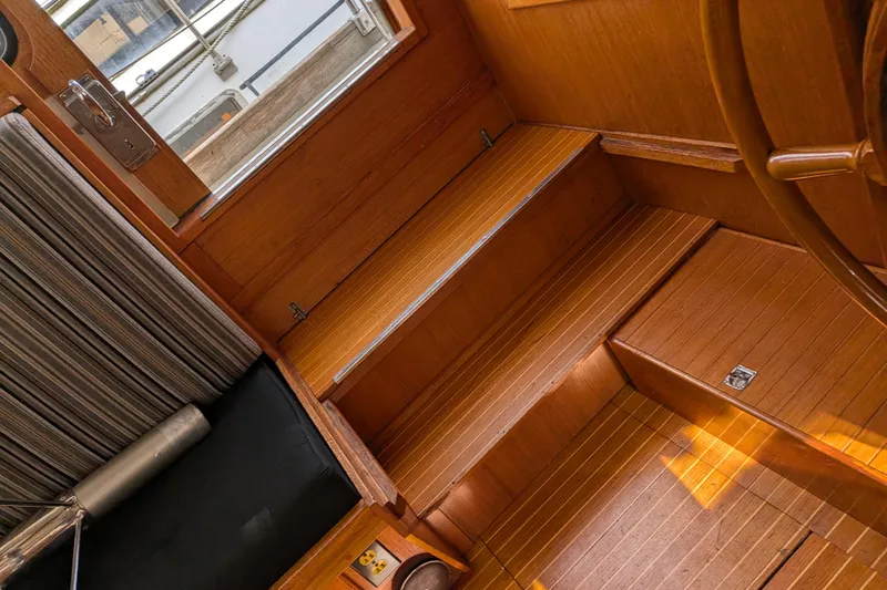 Firefly Yacht Photos Pics Interior of 1985 Siltala Nauticat 44 yacht, featuring wooden steps and nautical design.