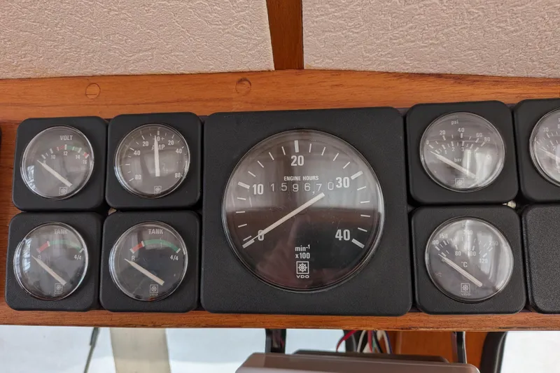 Firefly Yacht Photos Pics Dashboard gauges of a 1985 Siltala Nauticat 44 sailboat, displaying engine hours and tank levels.