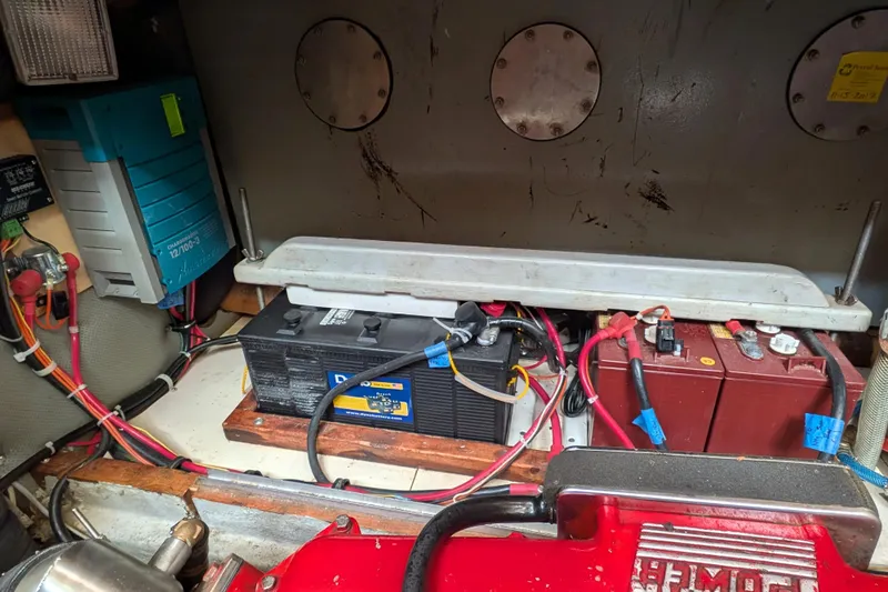Firefly Yacht Photos Pics Battery compartment of a 1985 Siltala Nauticat 44, featuring wiring and electrical components.