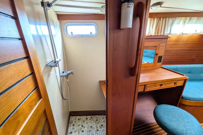 Firefly Yacht Photos Pics Interior of 1985 Siltala Nauticat 44 yacht featuring shower and wooden vanity area.
