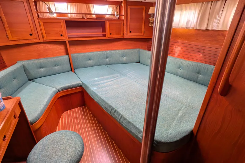 Firefly Yacht Photos Pics Interior of 1985 Siltala Nauticat 44 yacht with cozy seating and wooden finish.
