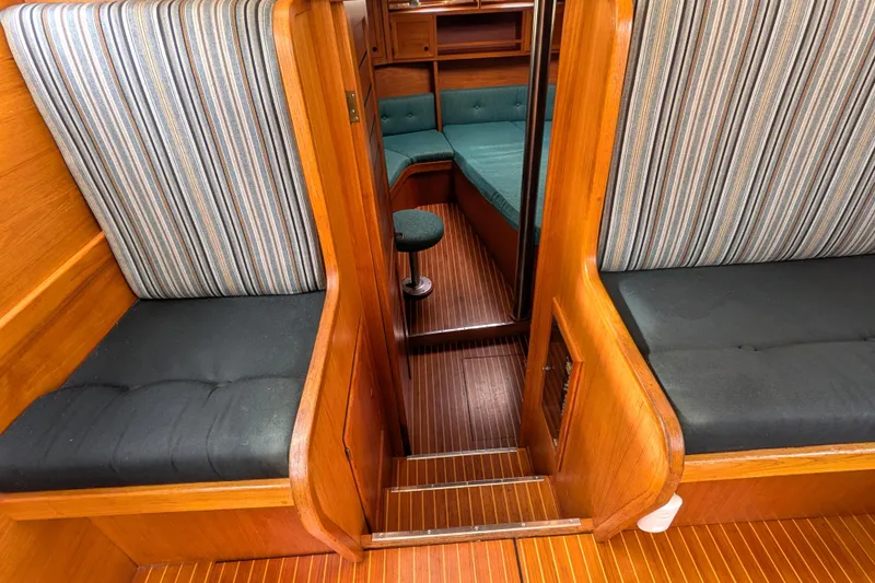 Firefly Yacht Photos Pics Interior of 1985 Siltala Nauticat 44 yacht with striped seating and wooden finish.