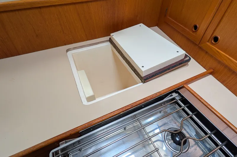 Firefly Yacht Photos Pics 1985 Siltala Nauticat 44 yacht kitchen with stove and storage compartment.