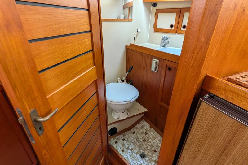 Firefly Yacht Photos Pics 1985 Siltala Nauticat 44 yacht bathroom with wooden interior and compact design.