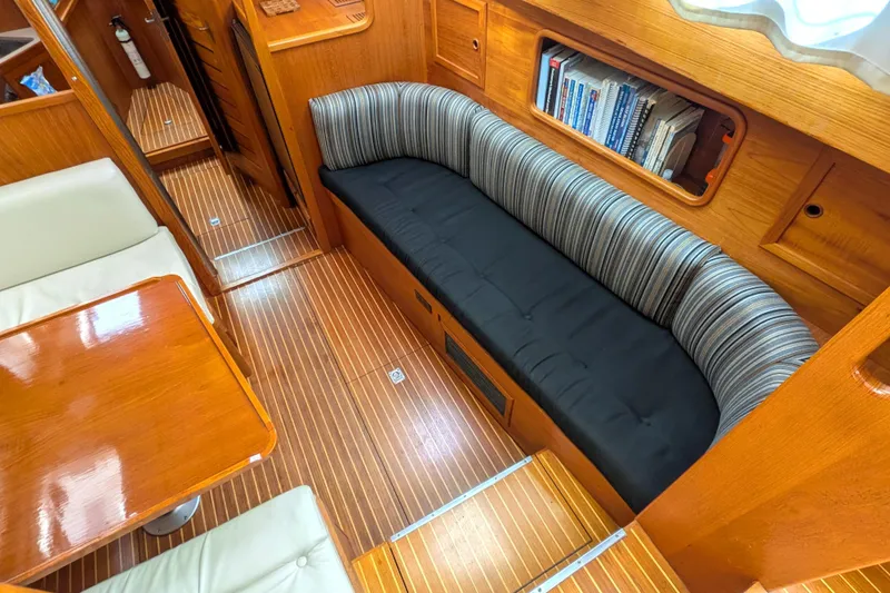 Firefly Yacht Photos Pics Interior of 1985 Siltala Nauticat 44 yacht with wooden flooring and cozy seating area.