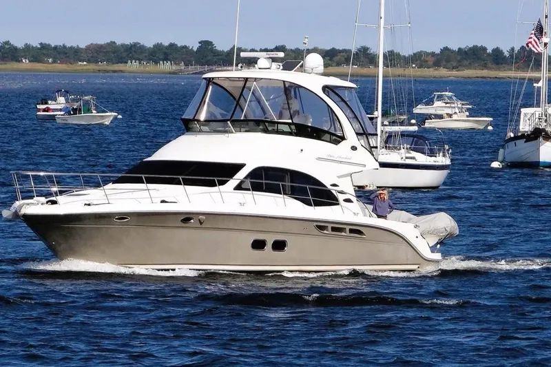 Knot Available Yacht Photos Pics 2005 Sea Ray 500 Sedan Bridge yacht cruising on a sunny day, surrounded by other boats.